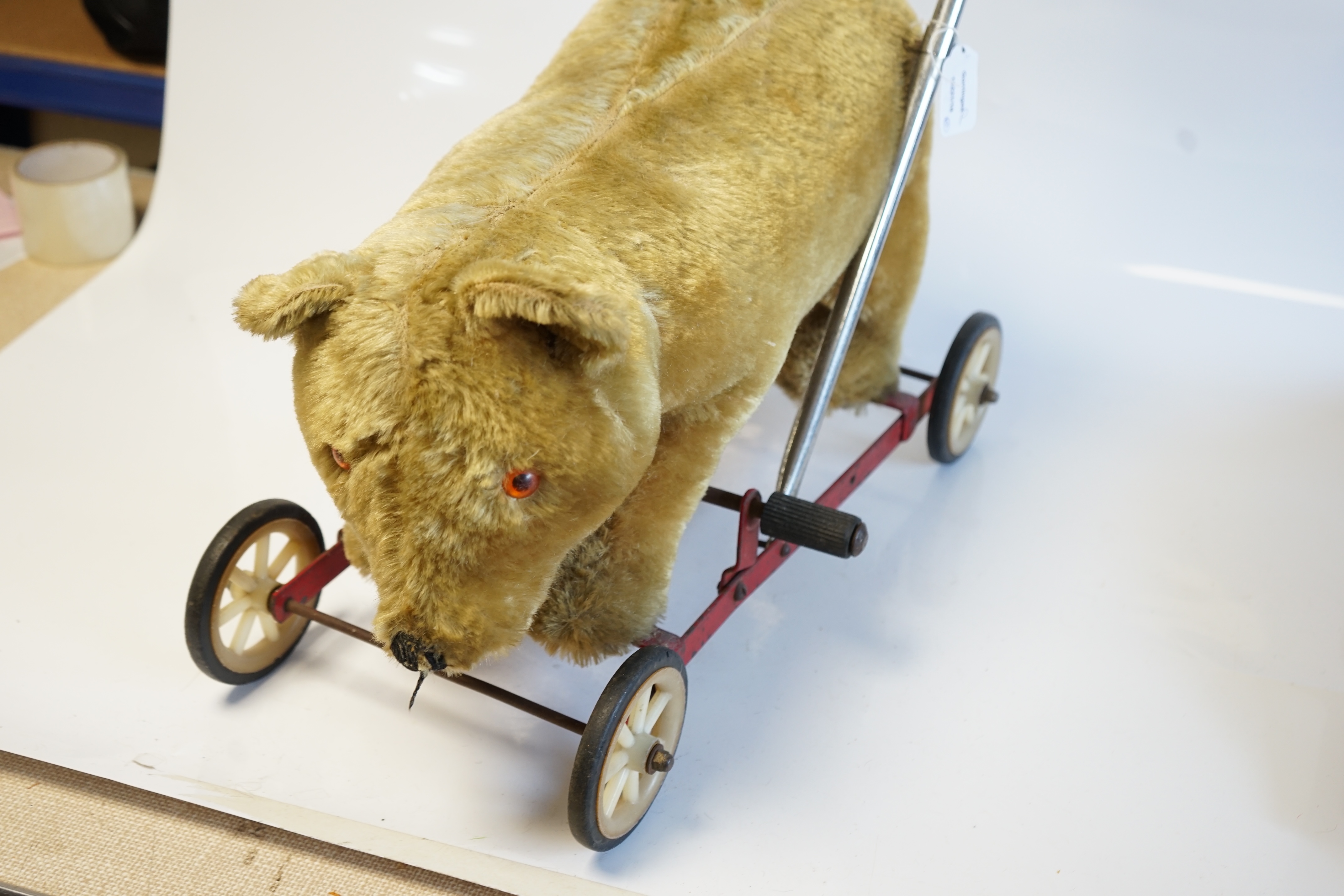 A Schuco Bigo Bello dog 'Lady', with collar and label, three Norah Wellings sailor dolls, four other toys, a 1930's Merrythought Teddy, with button and label, some hair loss, and a Merrythought dog on wheels (10). Condit